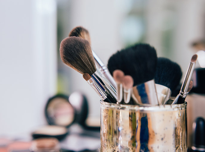 Set of clean makeup brushes in a container